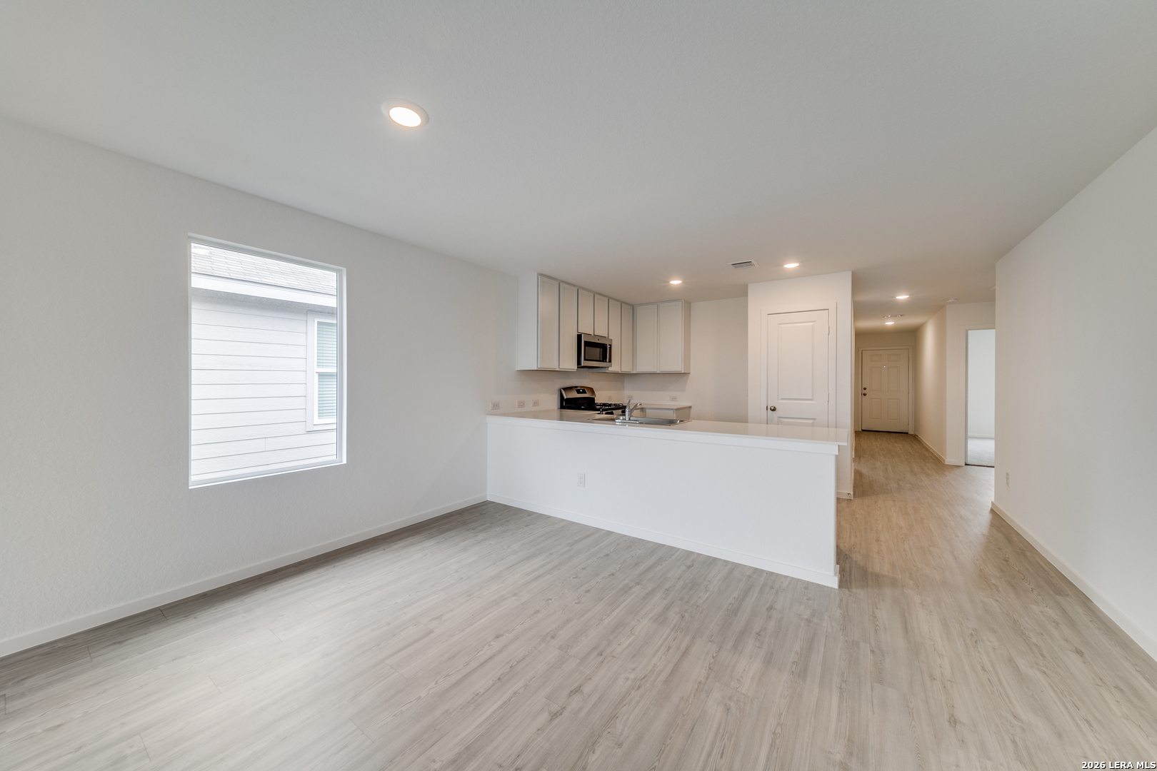 11621 Dog Rose Converse, TX 78109 - Photo 3 of 25 a view of kitchen with kitchen island white cabinets and wooden floor
