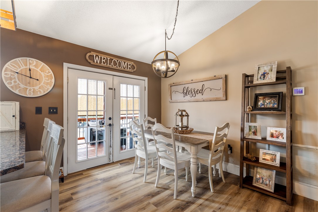 903 Huckleberry Lane Anderson, SC 29625 - Photo 11 of 42 This dining area features hardwood flooring and French doors leading to a deck.
