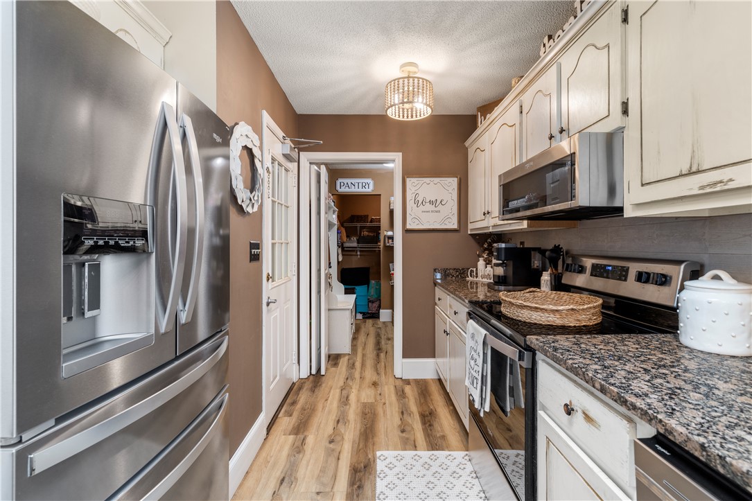 903 Huckleberry Lane Anderson, SC 29625 - Photo 16 of 42 This galley kitchen features durable flooring and granite countertops, creating a functional cooking space.