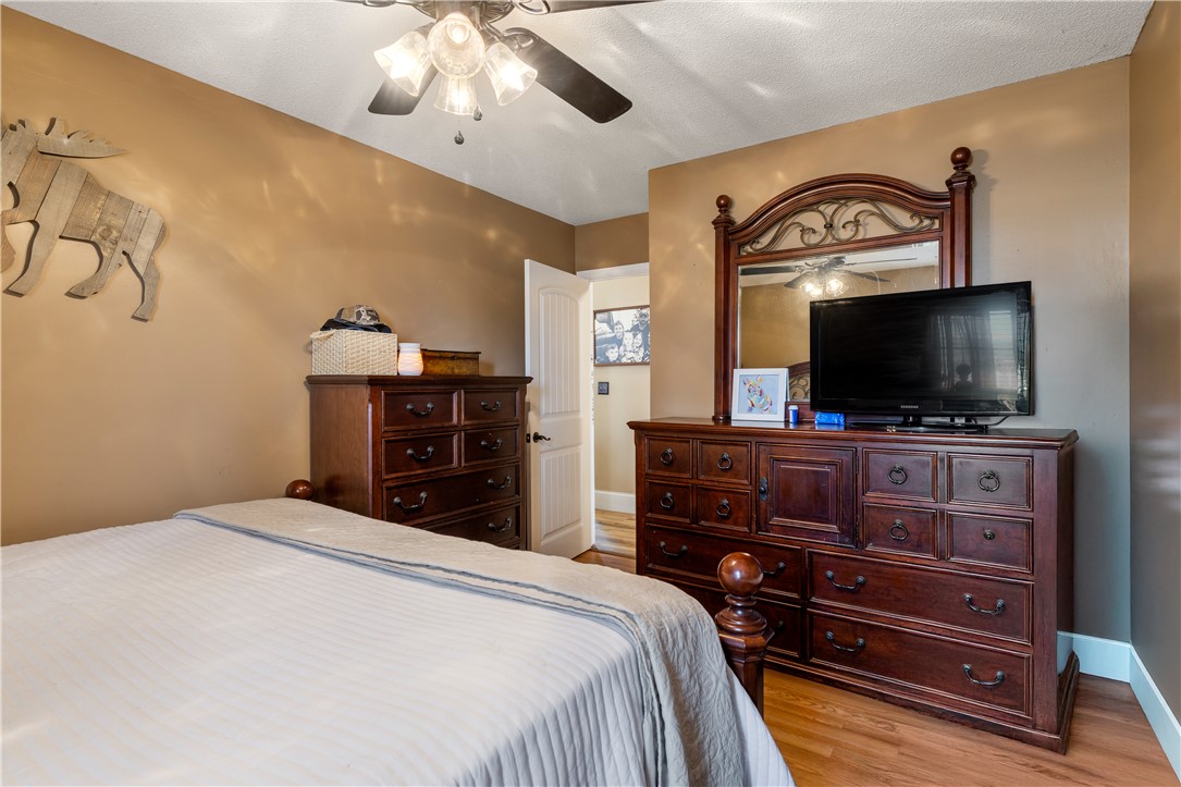 903 Huckleberry Lane Anderson, SC 29625 - Photo 20 of 42 This cozy bedroom offers a welcoming retreat with rich wood tones and thoughtful design elements.