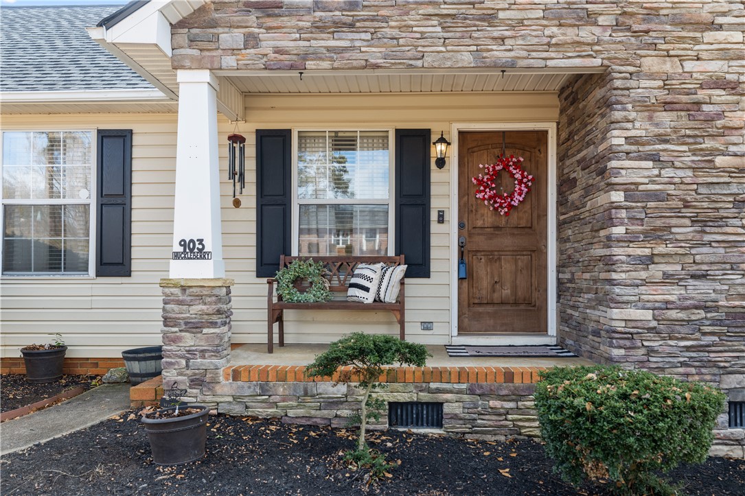 903 Huckleberry Lane Anderson, SC 29625 - Photo 2 of 42 This inviting home features a charming front porch with a wood door and stone accents.