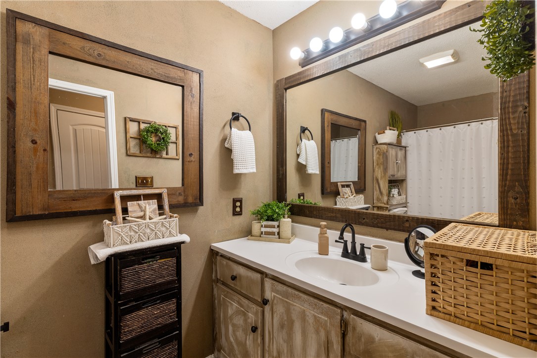 903 Huckleberry Lane Anderson, SC 29625 - Photo 21 of 42 This bathroom features rustic charm with wooden accents and a pristine white countertop.