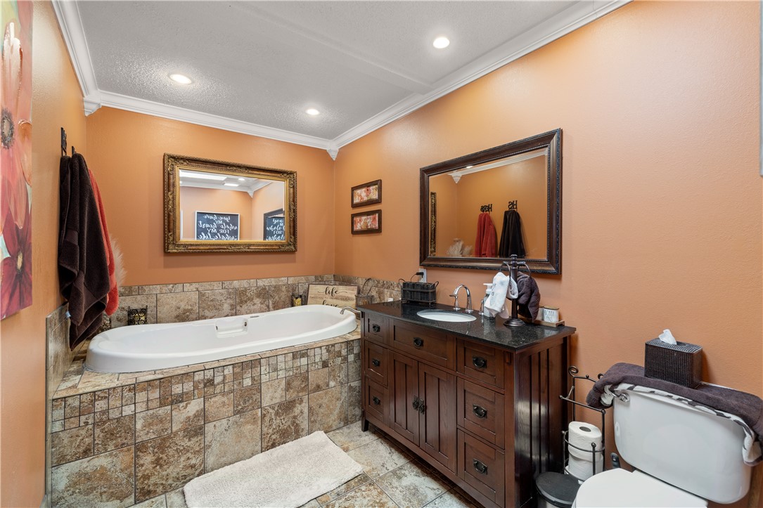 903 Huckleberry Lane Anderson, SC 29625 - Photo 27 of 42 This bathroom offers a large soaking tub and a vanity with a sleek granite countertop.