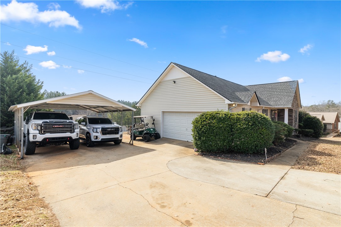 903 Huckleberry Lane Anderson, SC 29625 - Photo 5 of 42 This residence features a convenient carport and attached garage, offering ample parking and storage.