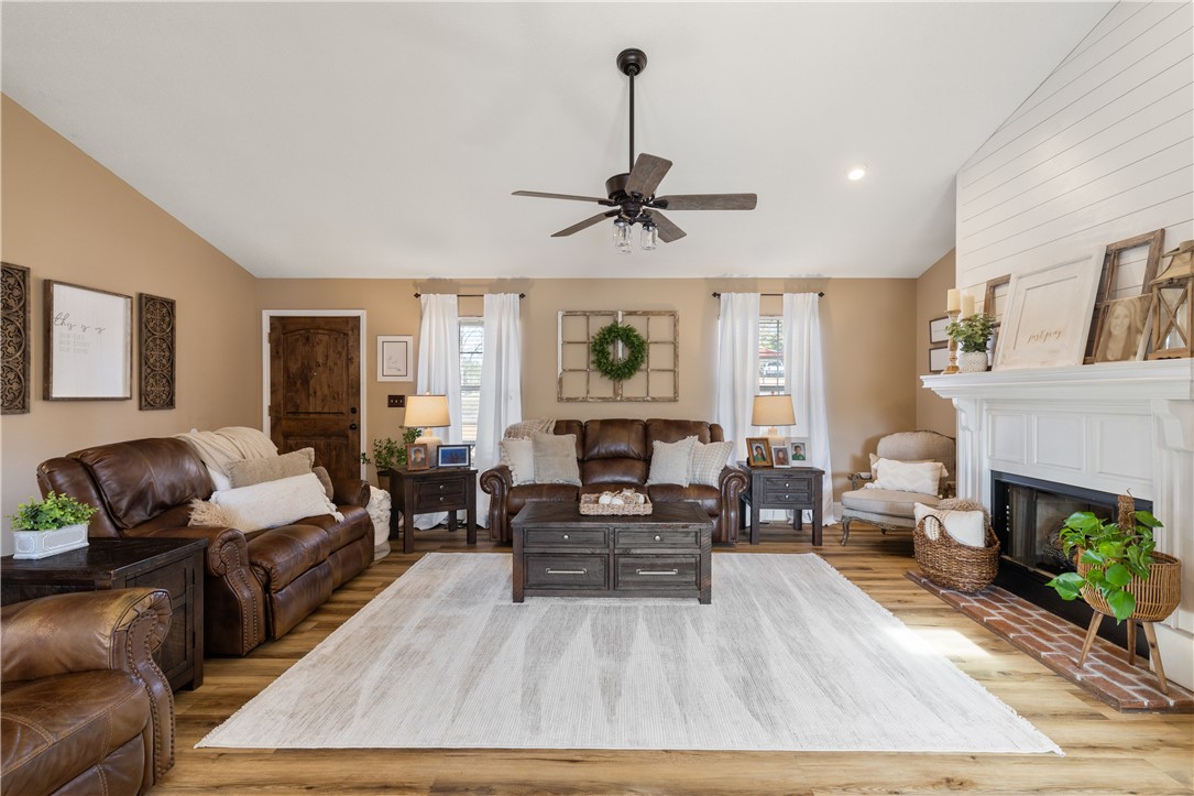 903 Huckleberry Lane Anderson, SC 29625 - Photo 8 of 42 This warm and inviting living room features a classic fireplace, vaulted ceilings, and rich wood flooring.