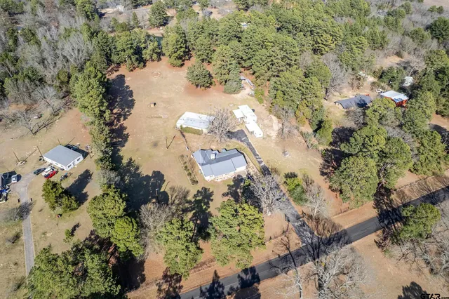 an aerial view of a houses with a yard