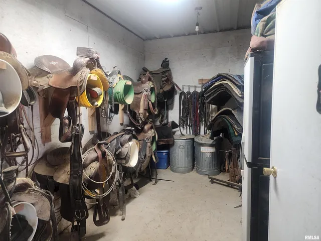 a view of staircase with lots of frames on wall and a window
