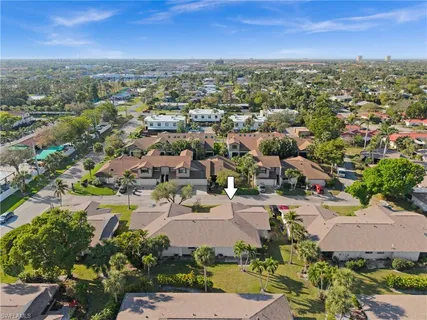 an aerial view of residential building with green space