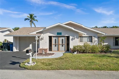 a view of a house with backyard porch and sitting area