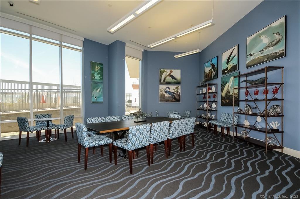 1 Harbor Point Road, Unit 1655 Stamford, CT 06902 - Photo 8 of 13 a dining room with furniture and wooden floor
