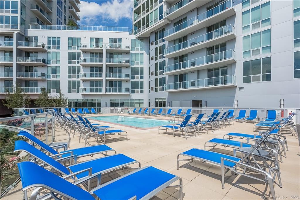 1 Harbor Point Road, Unit 1655 Stamford, CT 06902 - Photo 10 of 13 a front view of a building with swimming pool and sitting area