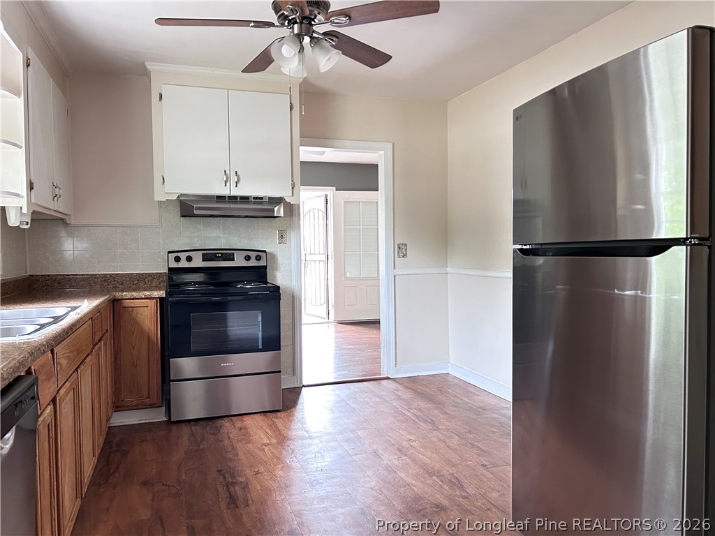 5200 Cypress Road Fayetteville, NC 28304 - Photo 5 of 9 a kitchen with a refrigerator and a stove top oven