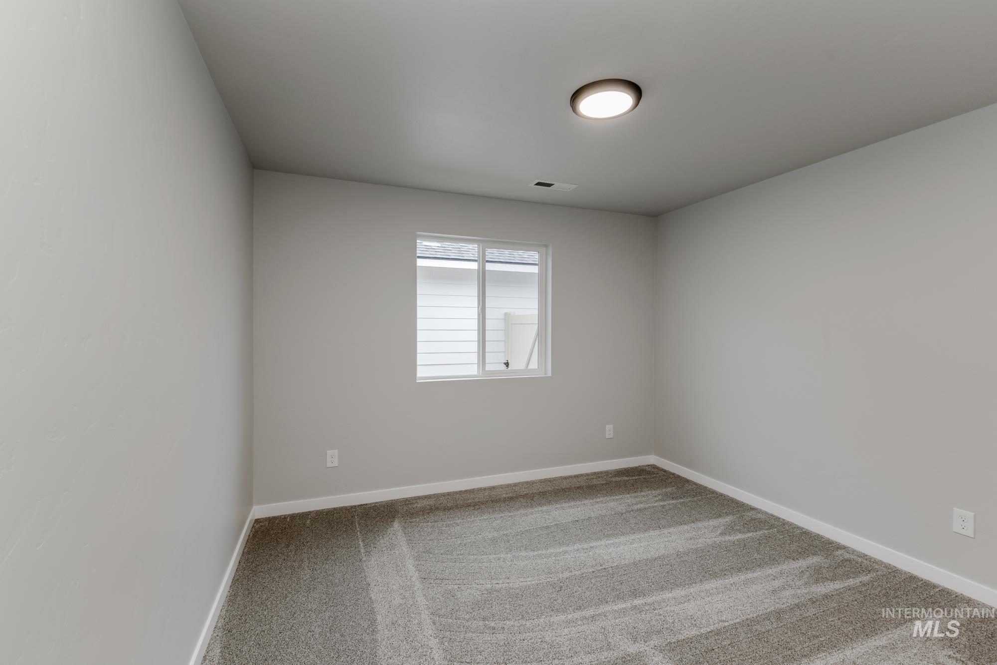 869 North Aleppo Way Meridian, ID 83642 - Photo 11 of 22 Spare room featuring light colored carpet and baseboards