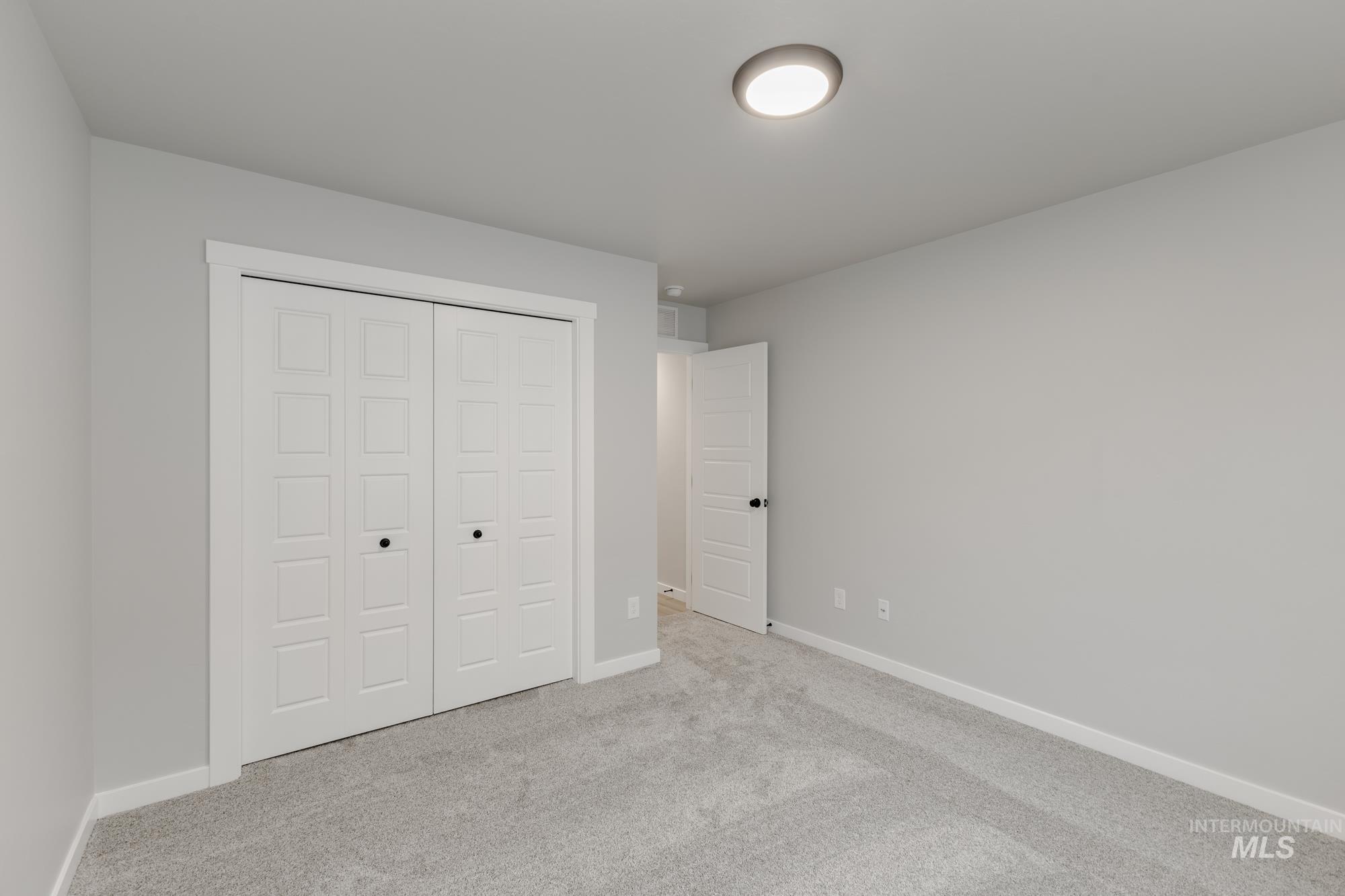 869 North Aleppo Way Meridian, ID 83642 - Photo 12 of 22 Unfurnished bedroom with carpet flooring and a closet