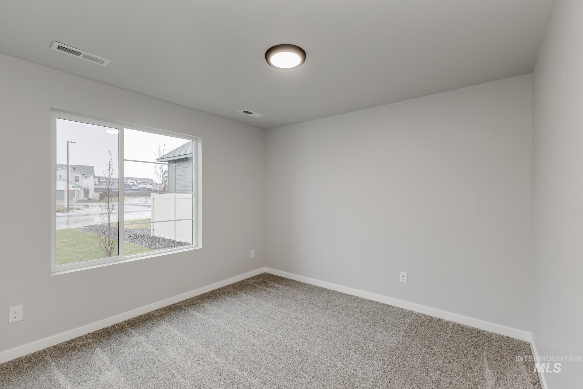 869 North Aleppo Way Meridian, ID 83642 - Photo 13 of 22 Unfurnished room featuring light carpet and baseboards