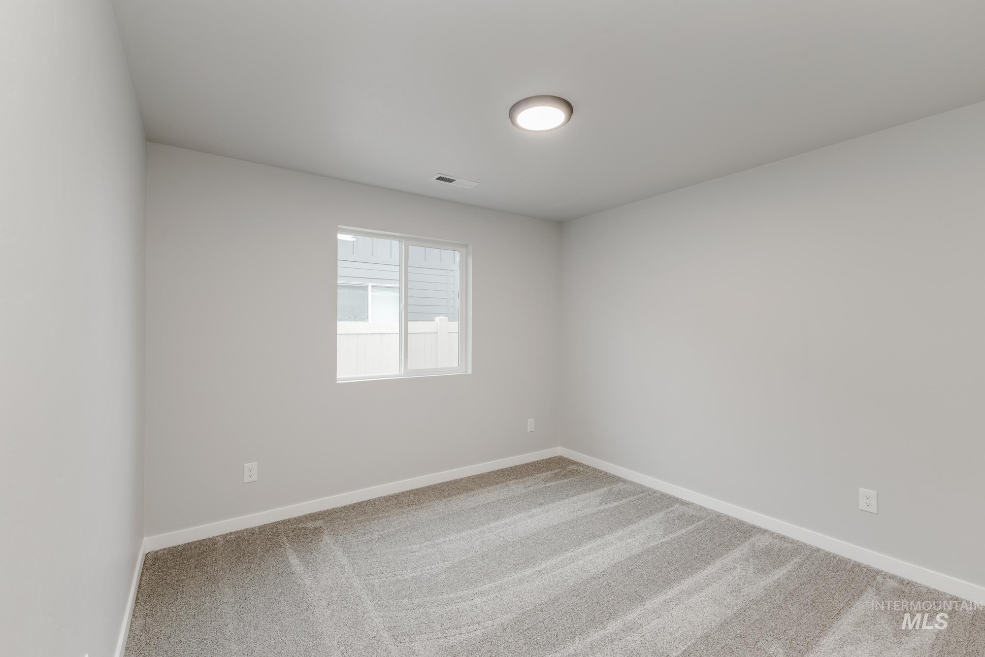869 North Aleppo Way Meridian, ID 83642 - Photo 15 of 22 Carpeted spare room featuring baseboards