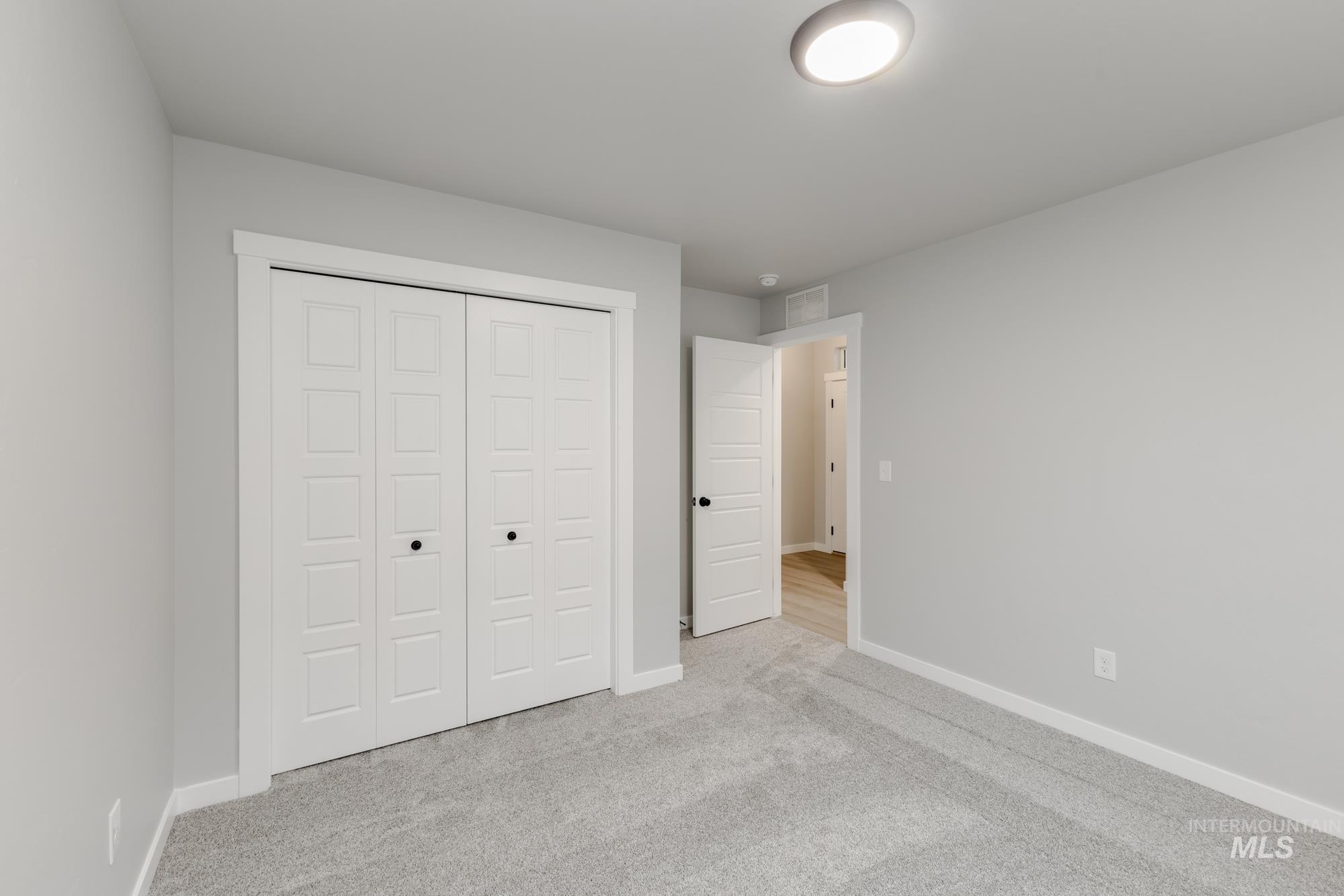 869 North Aleppo Way Meridian, ID 83642 - Photo 16 of 22 Unfurnished bedroom with carpet floors and a closet