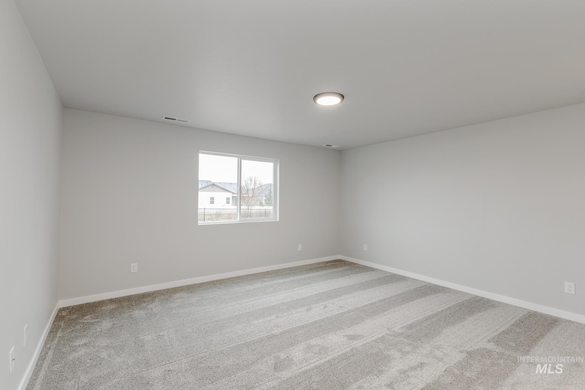 869 North Aleppo Way Meridian, ID 83642 - Photo 19 of 22 Empty room with light carpet and baseboards