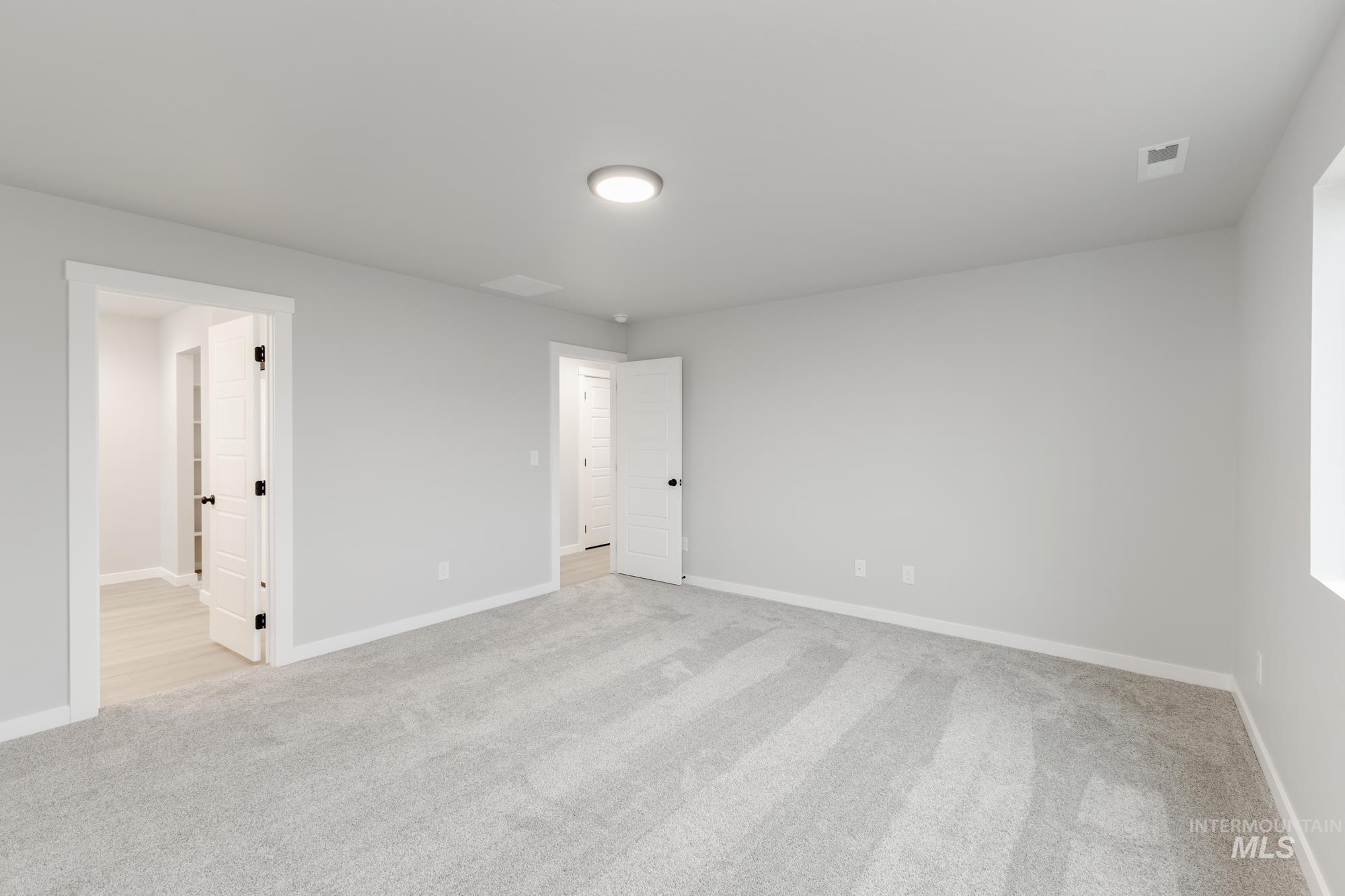 869 North Aleppo Way Meridian, ID 83642 - Photo 20 of 22 Unfurnished bedroom with light carpet and baseboards