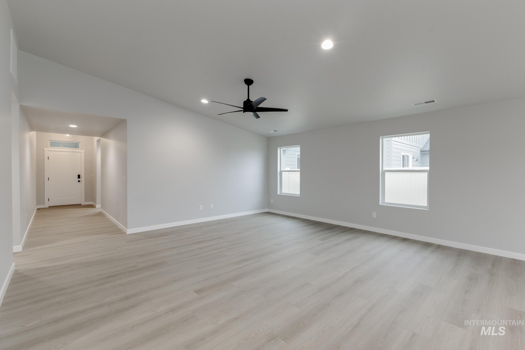 869 North Aleppo Way Meridian, ID 83642 - Photo 7 of 22 Spare room with lofted ceiling, recessed lighting, light wood-style flooring, and a ceiling fan