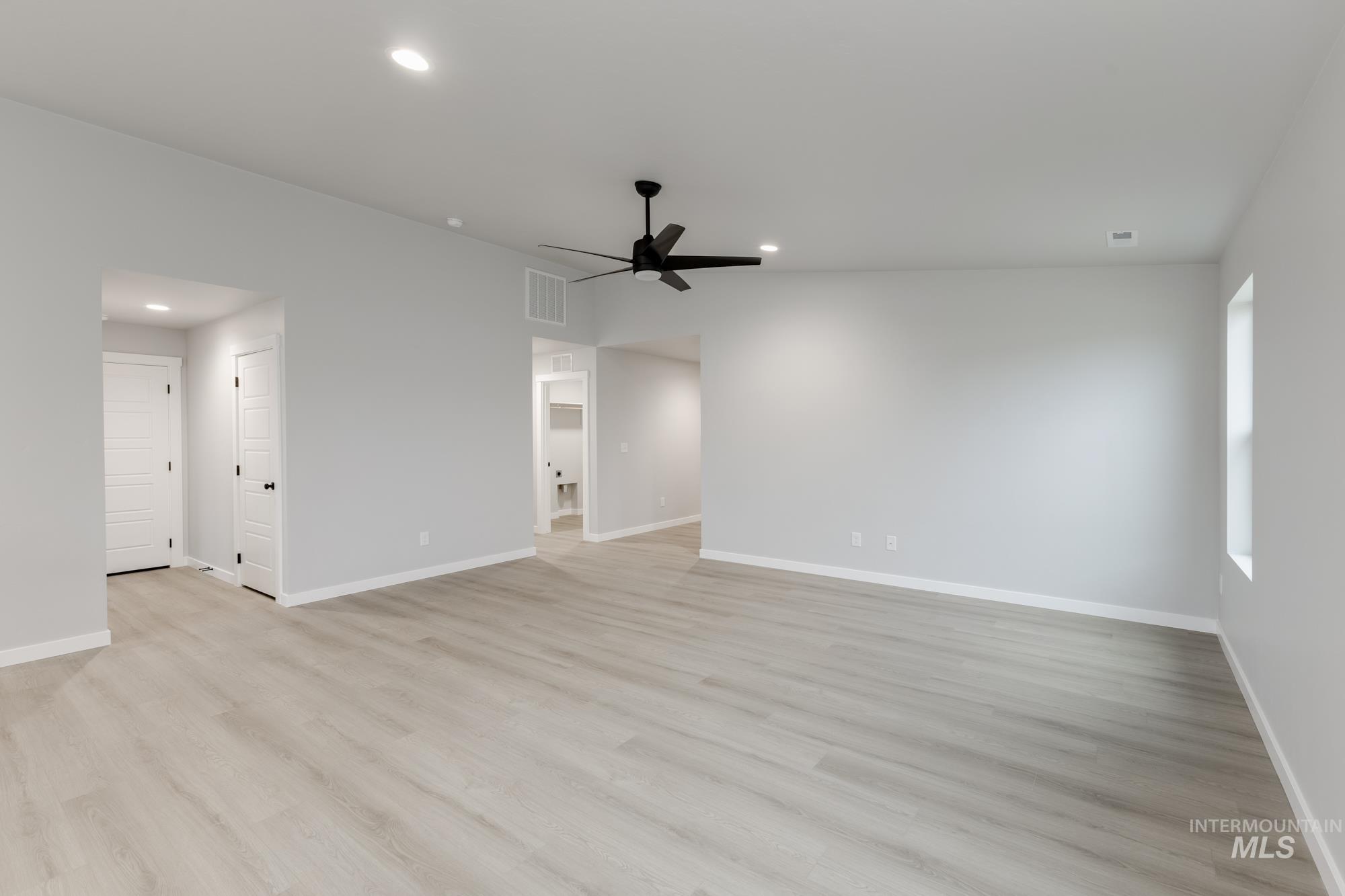869 North Aleppo Way Meridian, ID 83642 - Photo 8 of 22 Spare room with light wood-type flooring, recessed lighting, and ceiling fan