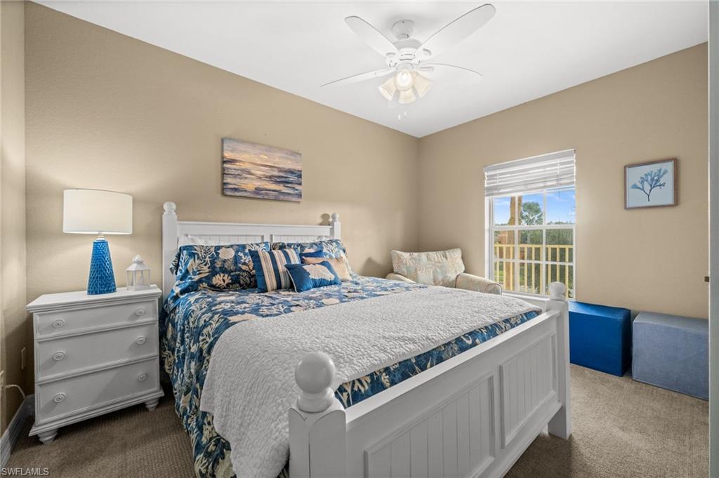 9175 Celeste Drive, Unit 306 Naples, FL 34113 - Photo 14 of 24 a bed sitting in a bedroom next to a window