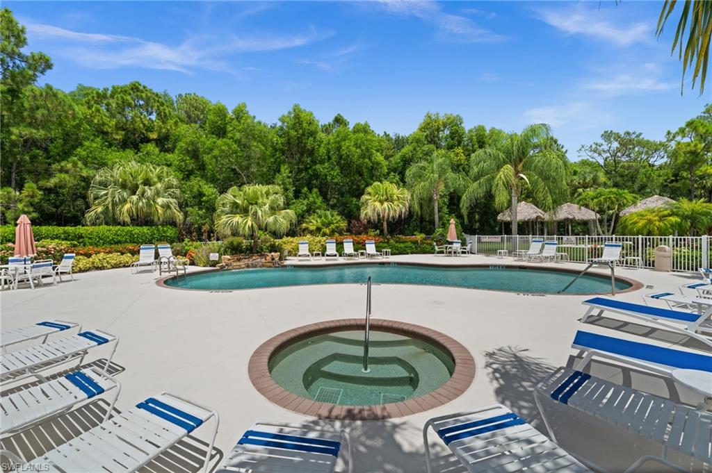 9175 Celeste Drive, Unit 306 Naples, FL 34113 - Photo 20 of 24 a view of a swimming pool and outdoor seating