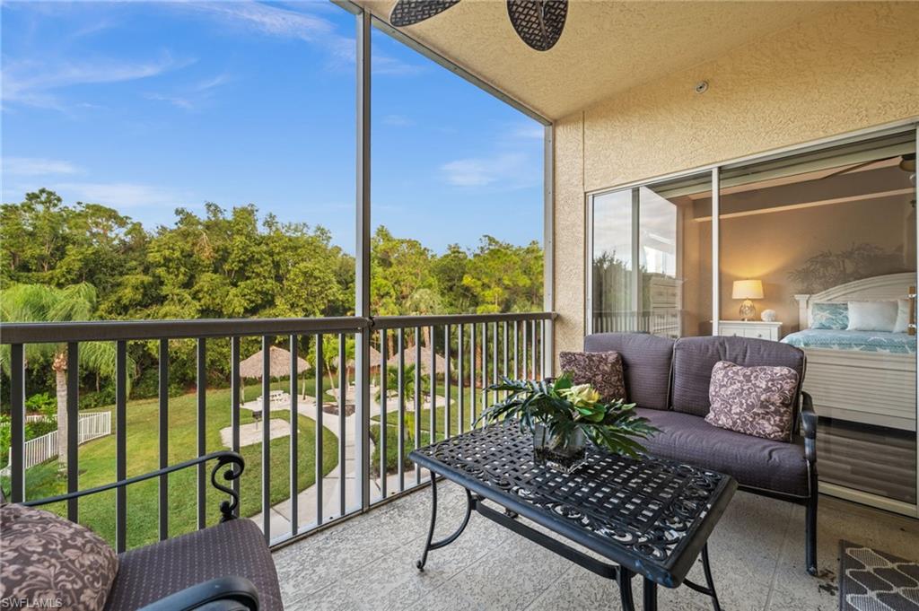 9175 Celeste Drive, Unit 306 Naples, FL 34113 - Photo 10 of 24 a living room with furniture and a floor to ceiling window