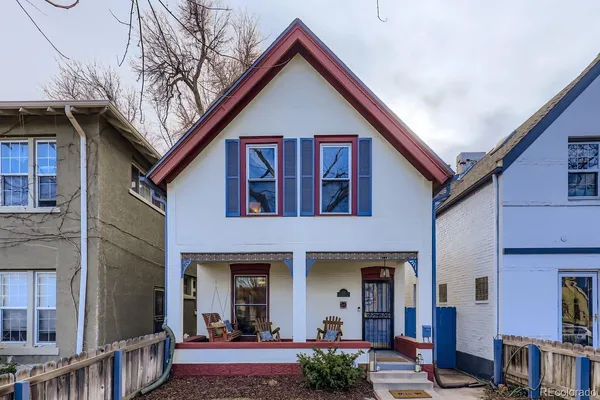 a view of a house with street and chairs