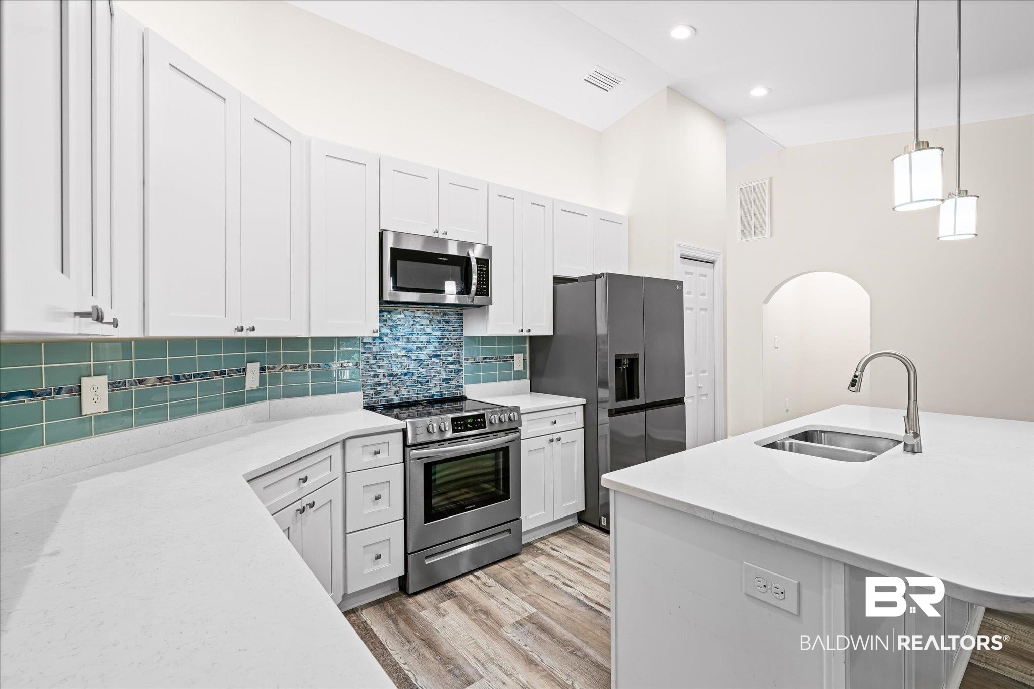 113 Pineridge Road Daphne, AL 36526 - Photo 6 of 22 Kitchen featuring white cabinets, appliances with stainless steel finishes, pendant lighting, and sink
