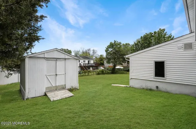 a big white house with a big yard and big trees
