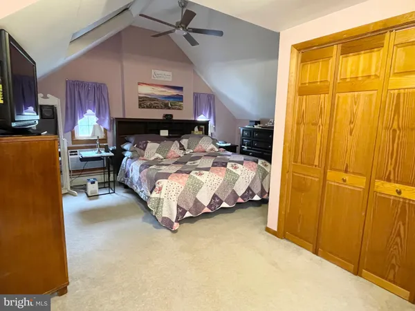 a bedroom with a bed dresser and a window