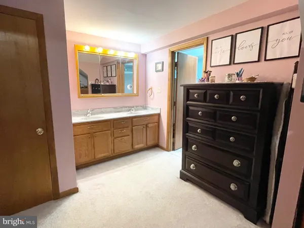 a bathroom with a double vanity sink and a mirror