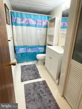 a bathroom with a granite countertop shower and a sink
