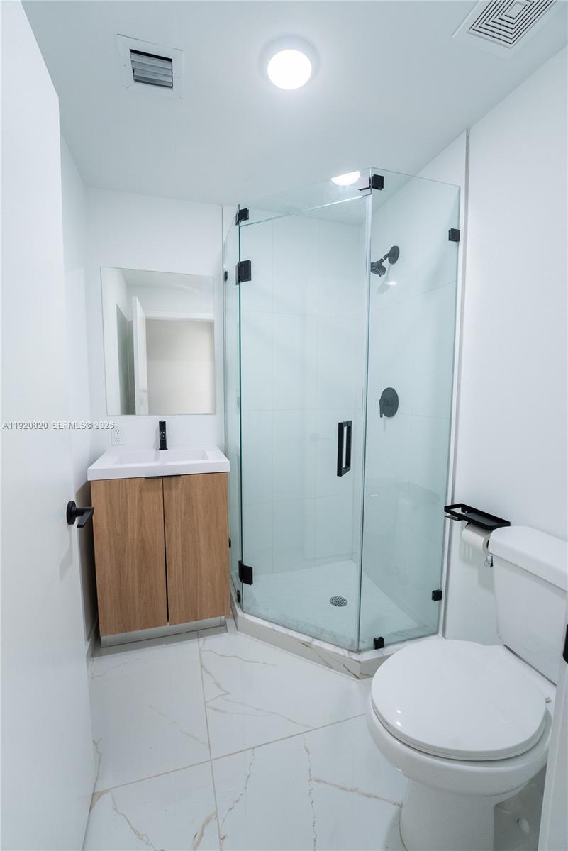 14580 Southwest 261st Street Homestead, FL 33032 - Photo 12 of 23 a bathroom with a toilet a sink and shower
