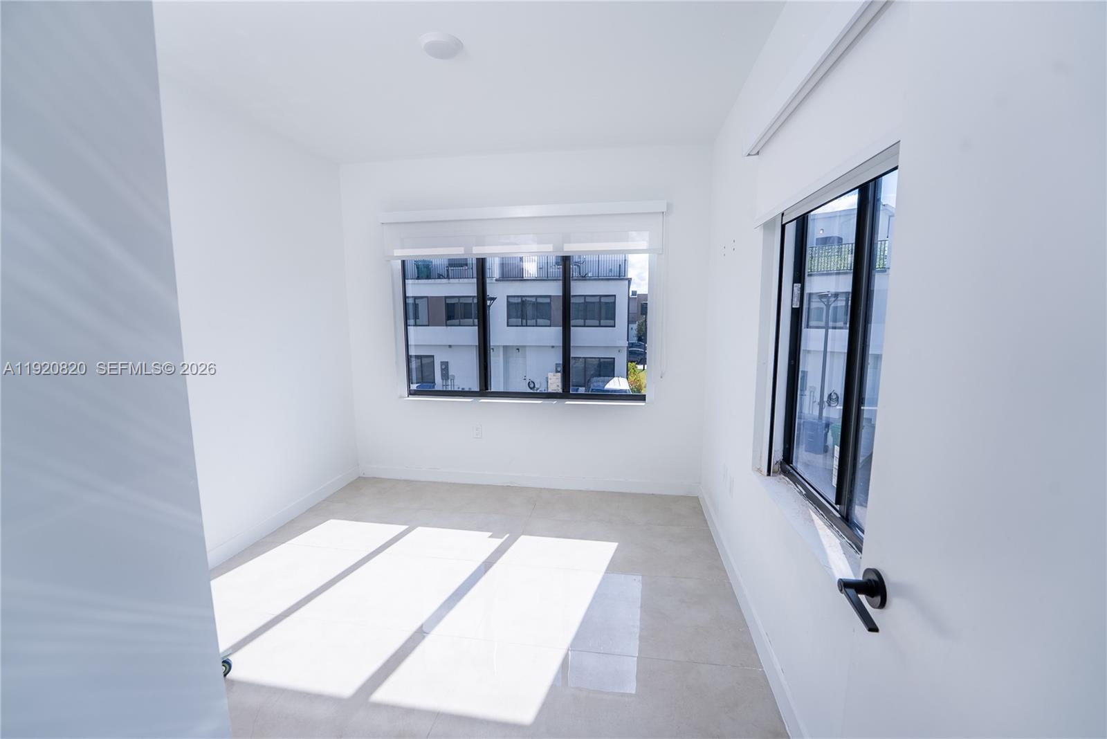 14580 Southwest 261st Street Homestead, FL 33032 - Photo 13 of 23 an empty room with windows