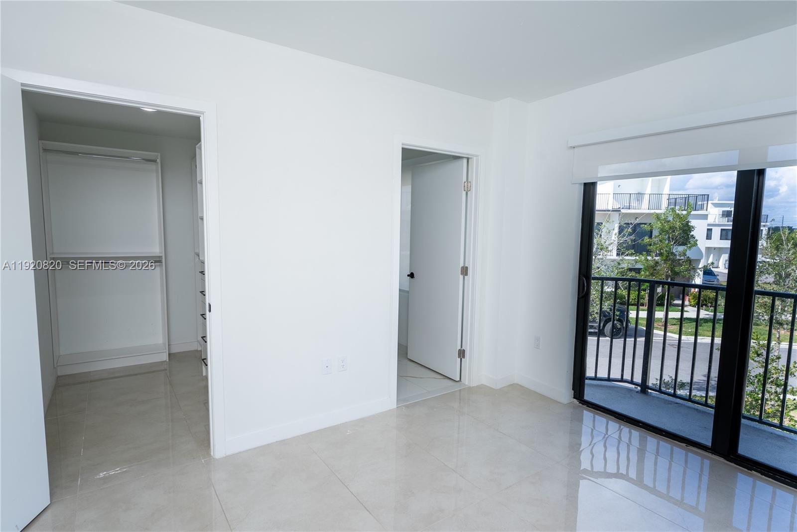 14580 Southwest 261st Street Homestead, FL 33032 - Photo 18 of 23 an empty room with wooden floor and a window