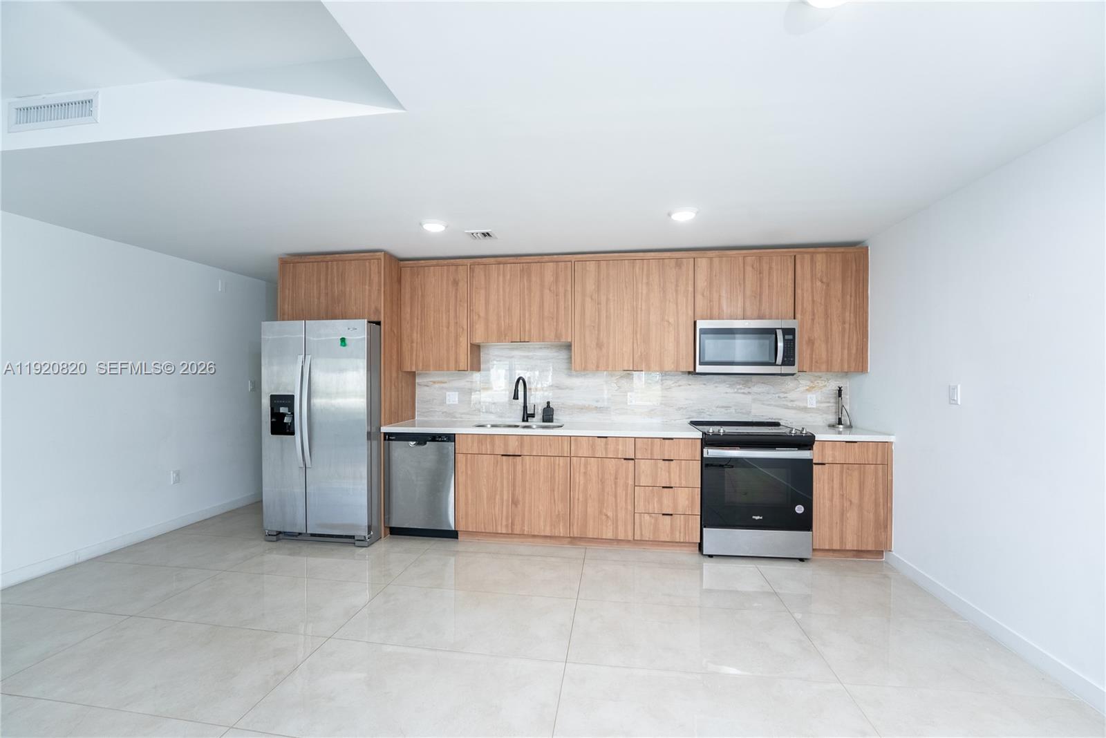 14580 Southwest 261st Street Homestead, FL 33032 - Photo 7 of 23 a kitchen with stainless steel appliances granite countertop a refrigerator stove top oven a sink and dishwasher