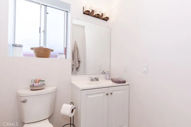 a bathroom with a sink vanity and toilet