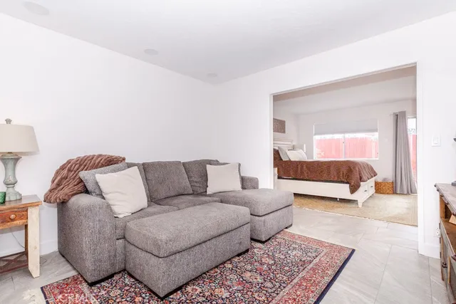 a living room with a couch and a lamp