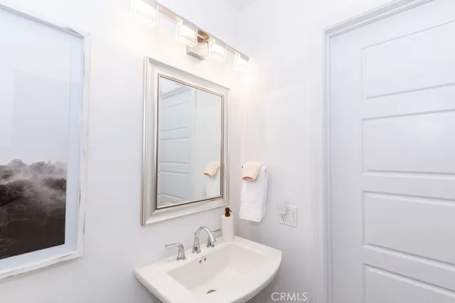 a kitchen with a sink a counter top space and stainless steel appliances