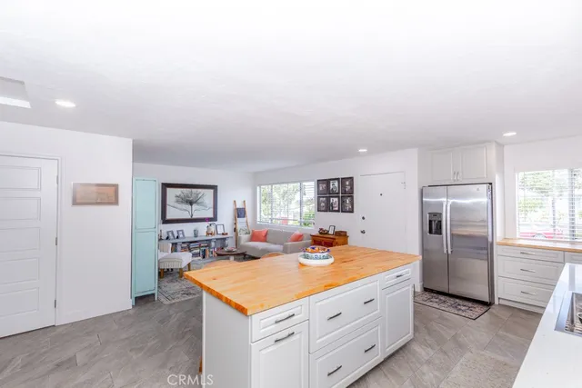 a large kitchen with stainless steel appliances granite countertop a sink and cabinets