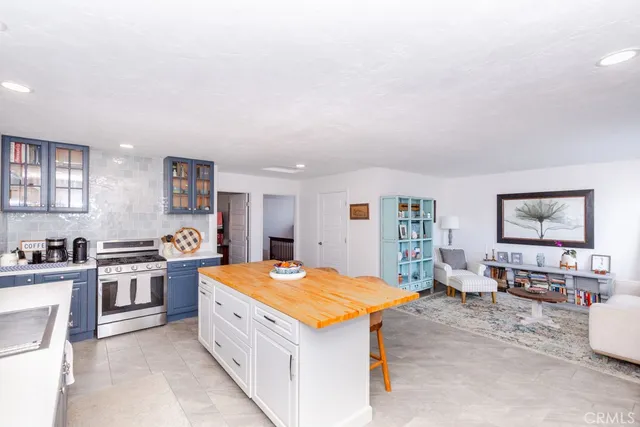 a kitchen with stainless steel appliances granite countertop a refrigerator and a stove