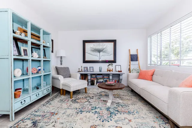 a living room with lots of baby toys and a book shelf