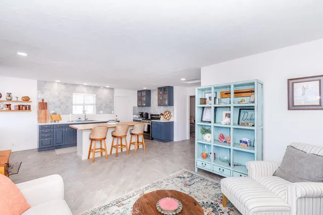 a view of a backyard with potted plants and wooden fence