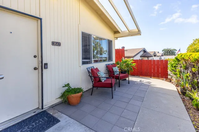 a backyard of a house with outdoor seating