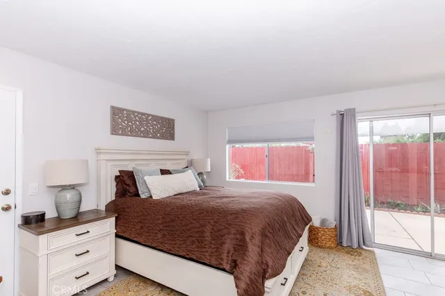 a bedroom with a bed and large window