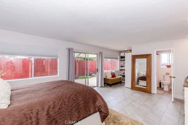 a spacious bedroom with a bed and a couch