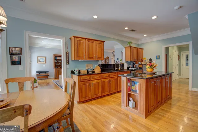 a kitchen with stainless steel appliances granite countertop a stove a sink and a refrigerator