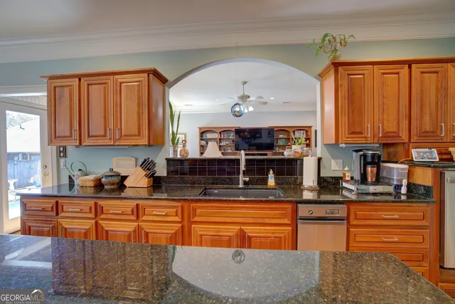 a room with a chandelier a dining table and chairs in it